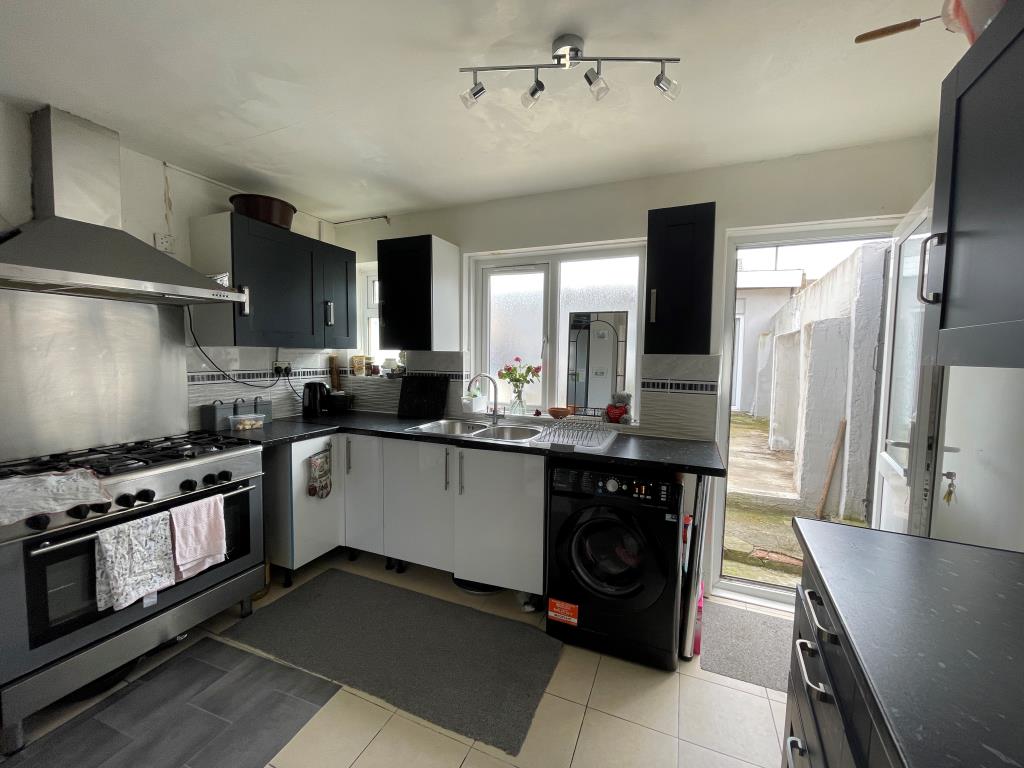 Lot: 123 - FREEHOLD RESIDENTIAL INVESTMENT - FOUR-BEDROOM HOUSE AND TWO STUDIOS - Kitchen with access to garden